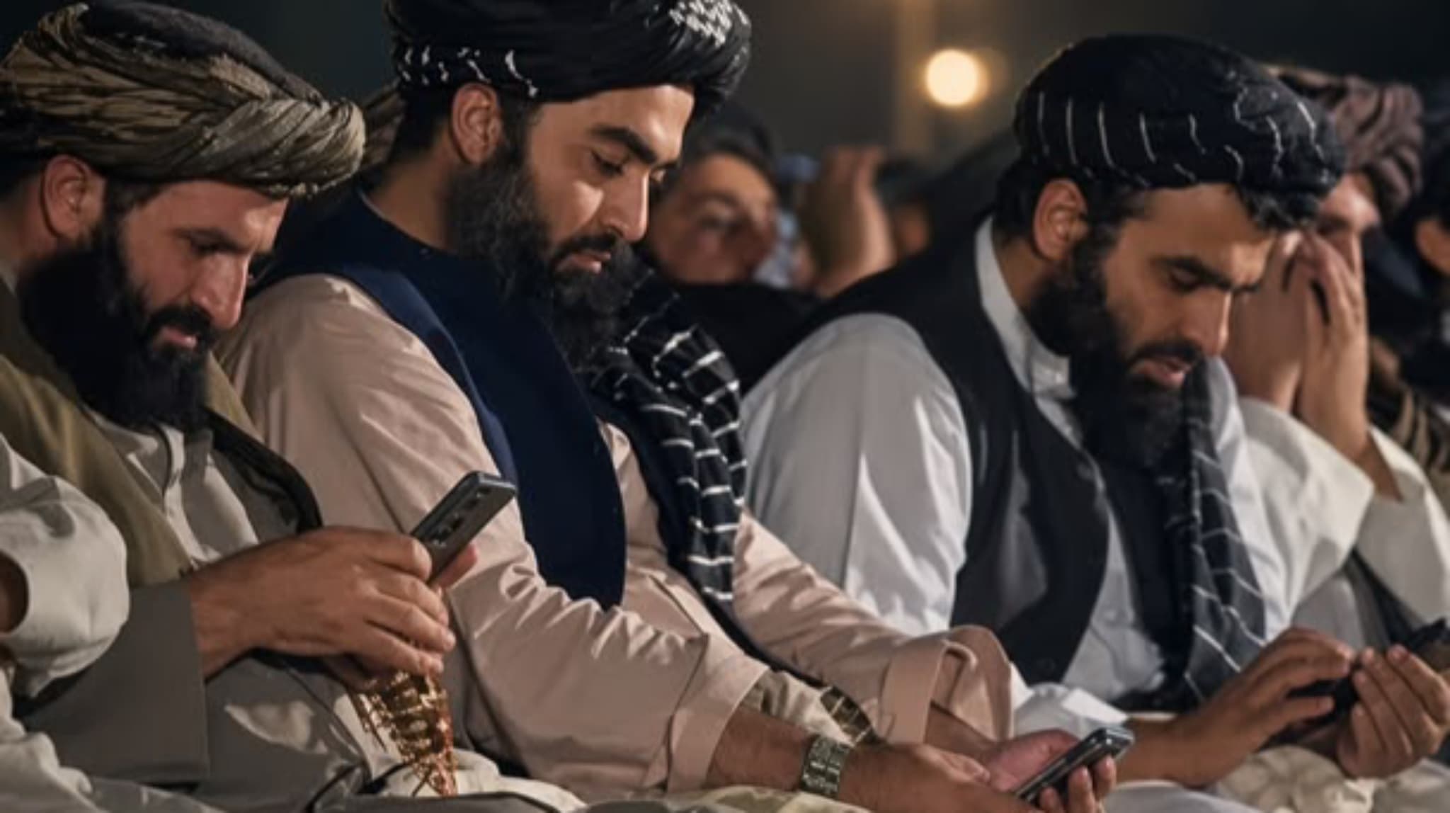 Smartphone ban order: Taliban officials seen using smartphones at official ceremony.
